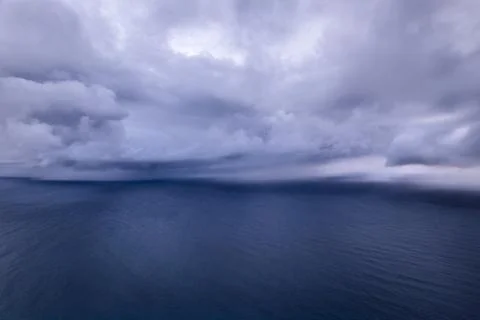 Heavy storm clouds gathering over the the ocean's surface Stock Photos