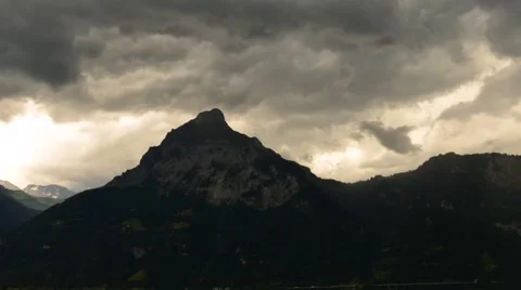 Heavy storm clouds in the setting sun over the mountains. Stock Footage 64992530