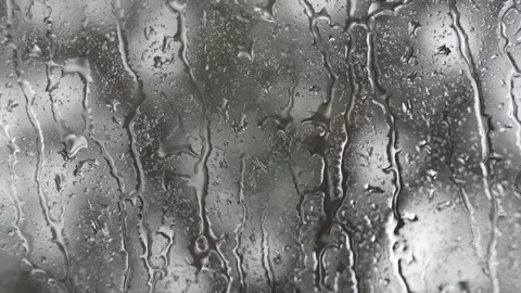 Heavy streams of rainwater running down a glass window Stock Footage 340833540
