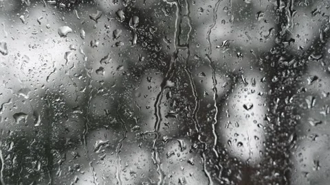 Heavy streams of rainwater running down a glass window Stock Footage 340834066