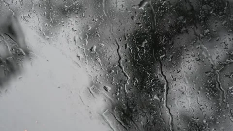 Heavy streams of rainwater running down a glass window Stock Footage 340834259