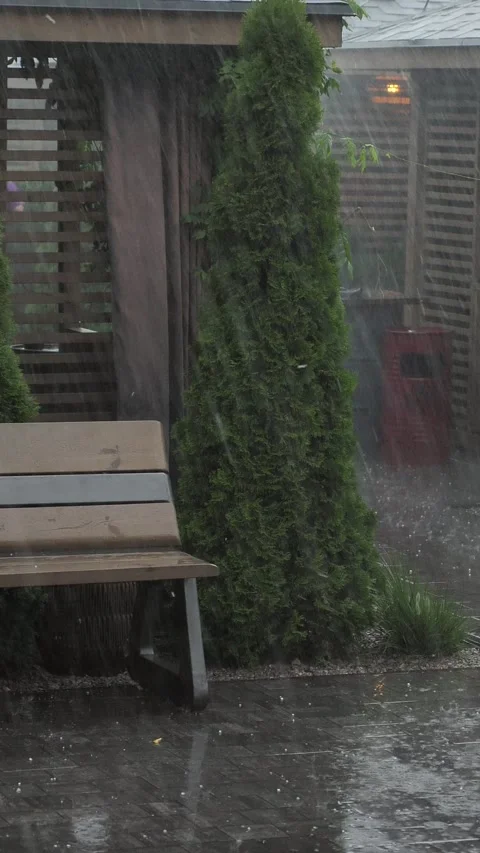 A heavy summer rain falls on an empty street terrace. Stock Footage 344913343