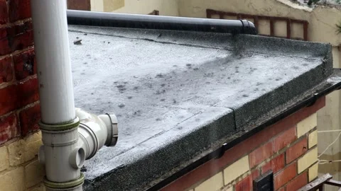 Heavy Summer Rain On a Flat Roof Of A Kitchen Extension Stock Footage