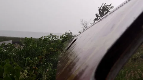 Heavy summer rain pouring down on rusty metal surface outdoors Stock-Footage 339590437