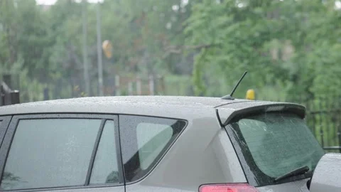 Heavy summer raindrops fall car roof surface. rainy weather rain drops knock Stock Footage 238705854