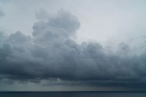 Heavy thunder clouds forming over the ocean Stock Photos