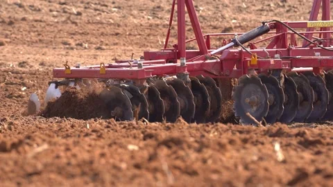 A heavy tracked tractor plows and buries a field in early spring, a plowed field Stock Footage 156076333