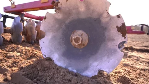 A heavy tracked tractor plows and buries a field in early spring, a plowed field Video stock 156076572