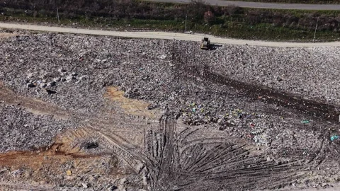 Heavy tracks and garbage piles on a dump site Vídeos de archivo 338188297