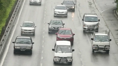 Heavy traffic drives through the rain Stock Footage 72348896