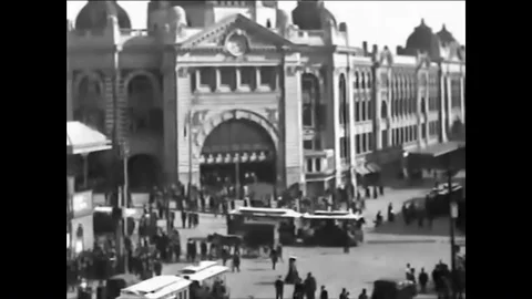 Heavy traffic on Flinders Street include streetcars, horse and carriages, and Stock Footage 85771642