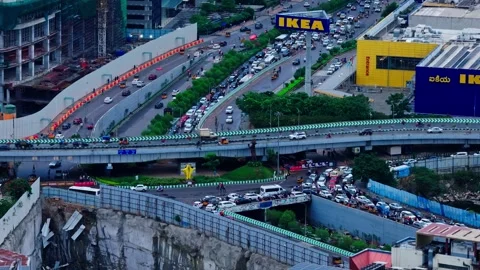 Heavy traffic flow in underpass, overpass with flyover and ikea Furniture store Stock Footage 344167768