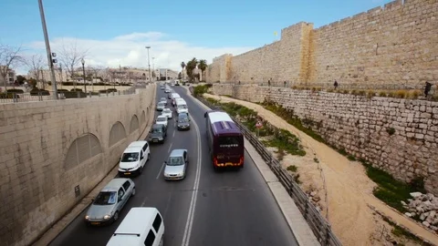 Heavy traffic on main road over bridge in Jerusalem old city Stock Footage 70933589