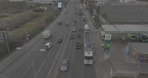 Heavy traffic on multilane road, car leaving gas station Stock-Footage 170905519