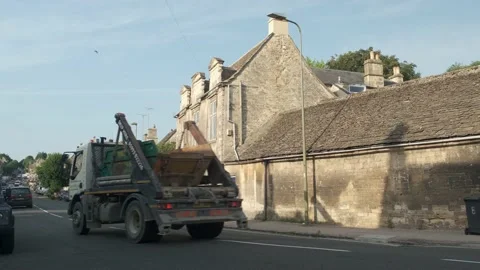 Heavy traffic passes main road in Burford village in the Cotswold's Stock Footage 202174772