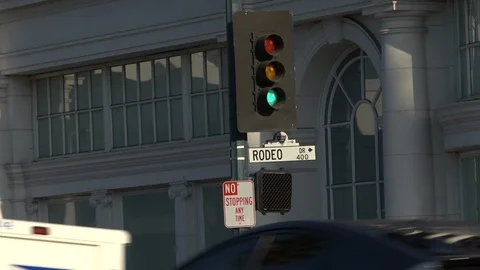 Heavy traffic passing beneath the Rodeo Drive sign, Beverly Hills Stock Footage 124176065