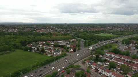 Heavy traffic at rush hour on multilane road leading through town neighbourhood Stock-Footage 155518616