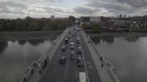Heavy traffic in town, queue of vehicles on bridge over river Video stock 167932513