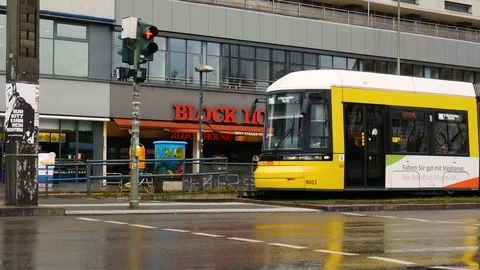 Heavy tram traffic at the stop in  Berlin / Downtown, a wet day Stock Footage 104099079