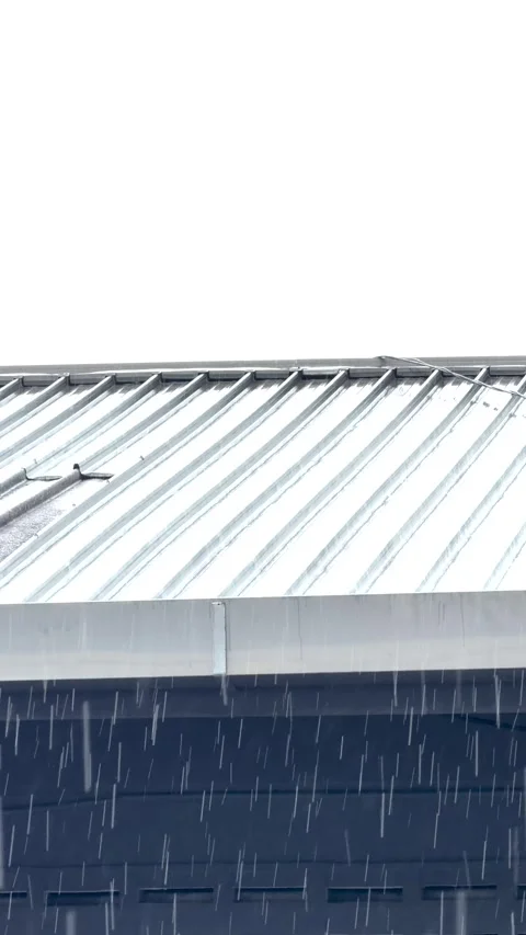 Heavy Tropical Rain Falling Past Corrugated Metal Roof - Vertical 4K Stock Footage 346007174