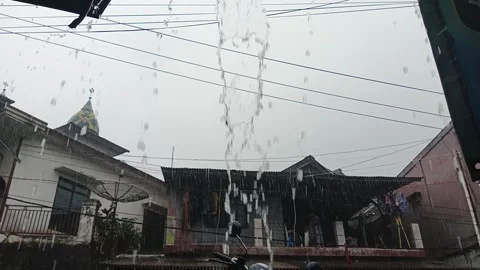 Heavy Tropical Rainfall Over Residential Area with Mosque Background Stock Footage 333696110