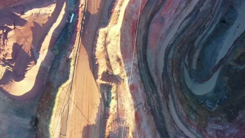 Heavy vehicles serpentine road down the bottom of deep open pit mine 4k. Stock Footage 168384232