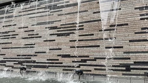 Heavy Water Streams Cascading Down Textured Stone Fountain Wall Video stock 342516209