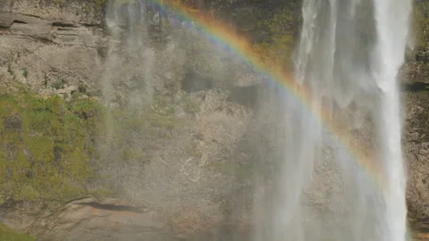 A heavy waterfall streams forming a beautiful rainbow. Stock Footage 283687157
