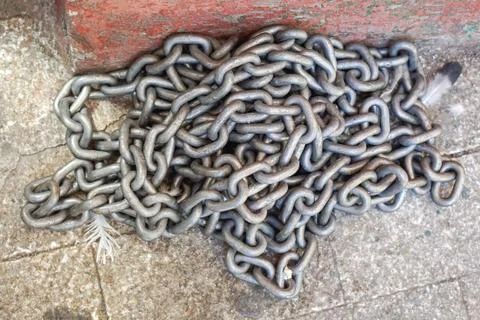 Heavy weight steel chains at floor Stock Photos