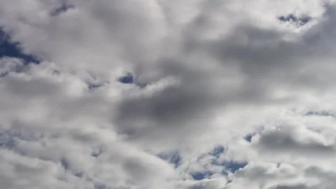 Heavy white clouds moving across an overcast grey sky Video stock 329752807