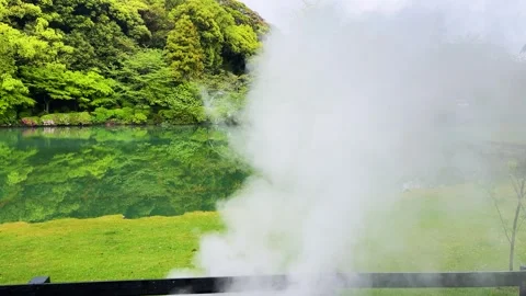 Heavy white steam rises from the thermal hot spring water surface. Stock Footage 334581206