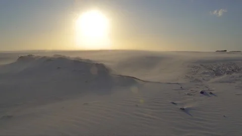 A heavy wind blows sand over a dune with hot desert sun. Stock Footage 97455077