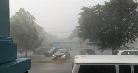 Heavy wind rain hurricane tropical storm weather on St Claude Ave New Orleans Stock Footage 140821863