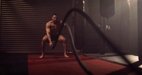 A Heavyweight Hispanic Bodybuilder Exercises Battle Ropes In A Crossfit Gym Stock Footage 158433502