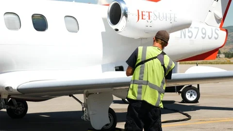 Heber airport worker is putting a note as he checks arrived plane Stock-Footage 116121515