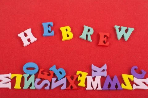HEBREW word on red background composed from colorful abc alphabet block woode Stock Photos