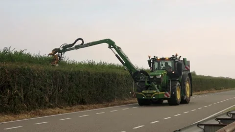 Hedge pruning using the tractor Video stock 254802441