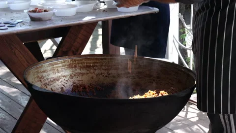 Hef cooking in a cauldron  Stock Footage 274433696