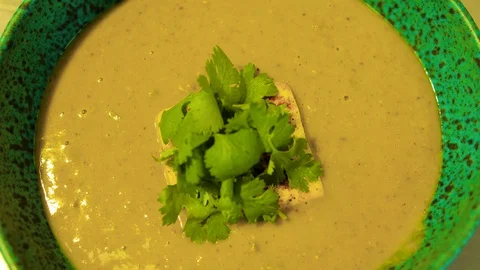 Hef decorates a vegetable soup with a green sauce, a vegetarian dish Stock Footage 113110184