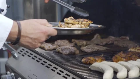 Hef grilling fresh meat steaks on brazier with hot flame Stock Footage 143196010