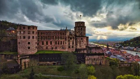 Heidelberg Castle stands on the hill while clouds gather over the town belo.. Stock Photos