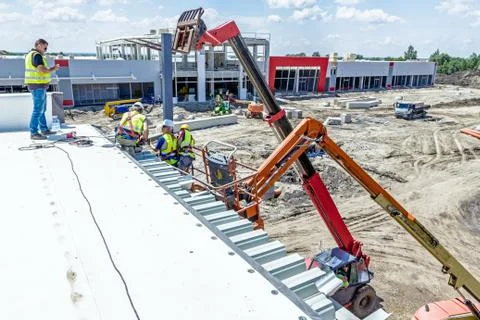 Height workers in cherry picker are working on new metal canopies Stock Photos
