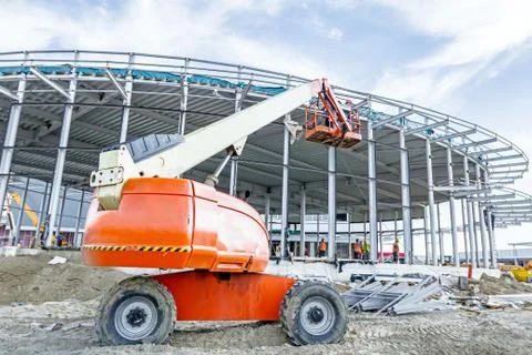 Height workers with help of cherry picker are working on new metal canopies Stock Photos