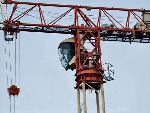 Heightened view of construction crane operator. Silhouette of heavy crane w.. Photos