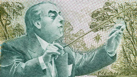 Heitor Villa-Lobos conducting an orchestra on Brazil banknote tracking. 4K Stock Footage 148436503