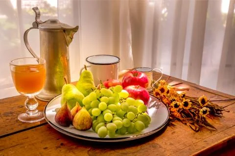 Helathy breakfast table in fall with apples, peers, grapes, figs and apple ju Stock Photos