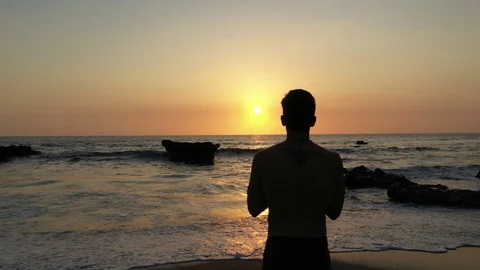 Held Over Shoulder Of Man Praying at Sunset Stock Footage 120131501
