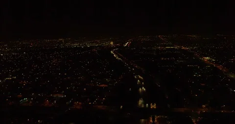 Helicopter aerial tracking over freeway during fireworks, night Stock Footage 102066586