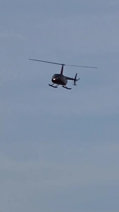 Helicopter approaching camera head robinson r44 r66 turbine rolls royce engine Stock Footage 282583545