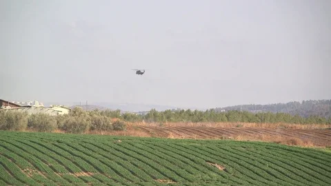 Helicopter approaching a village Stock Footage 76917676